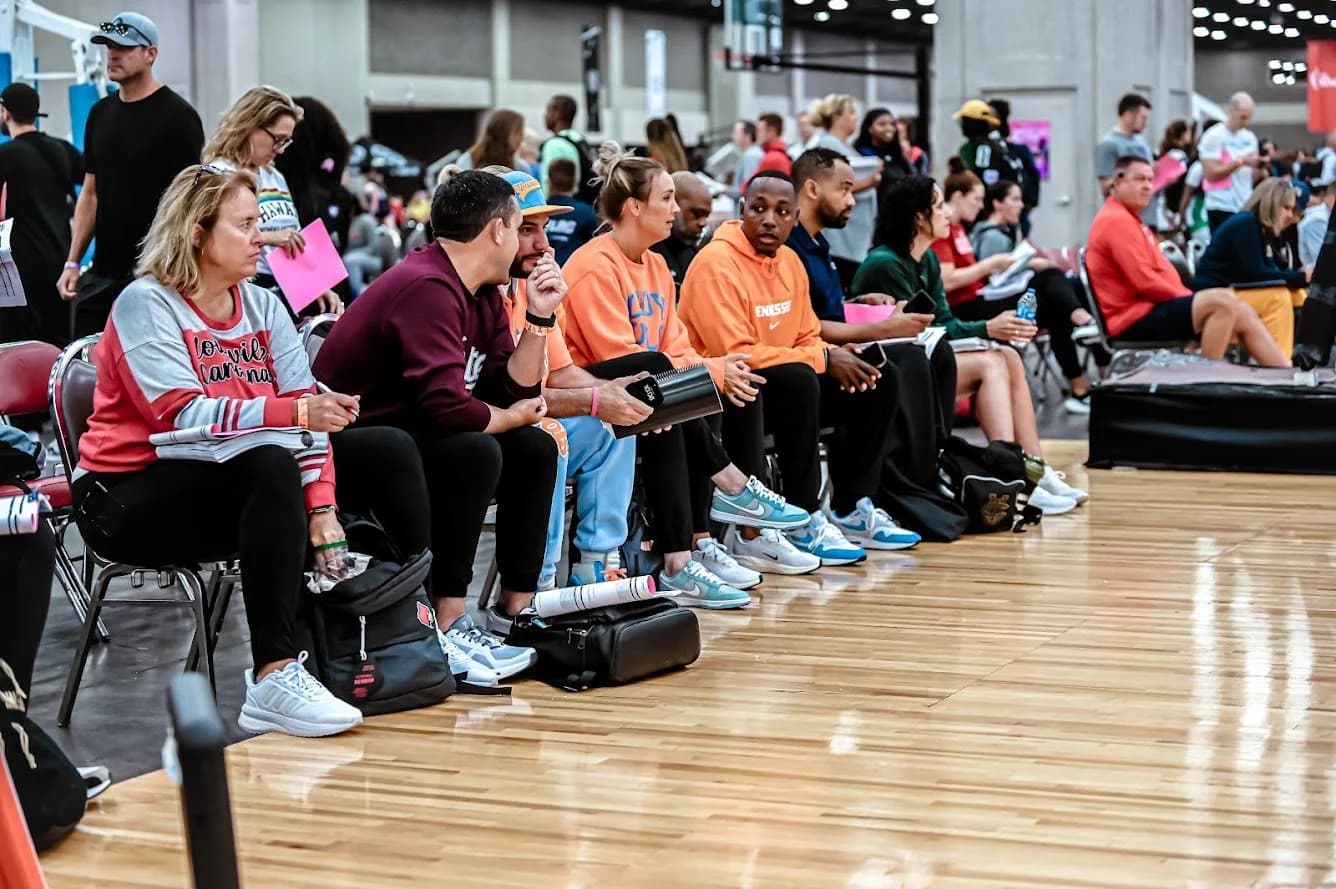 AUSA Hoops coach speaking with a player on the bench