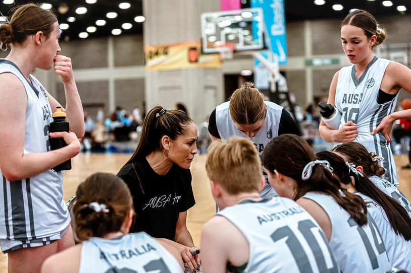 AUSA Hoops coaches talking with players during a break in play