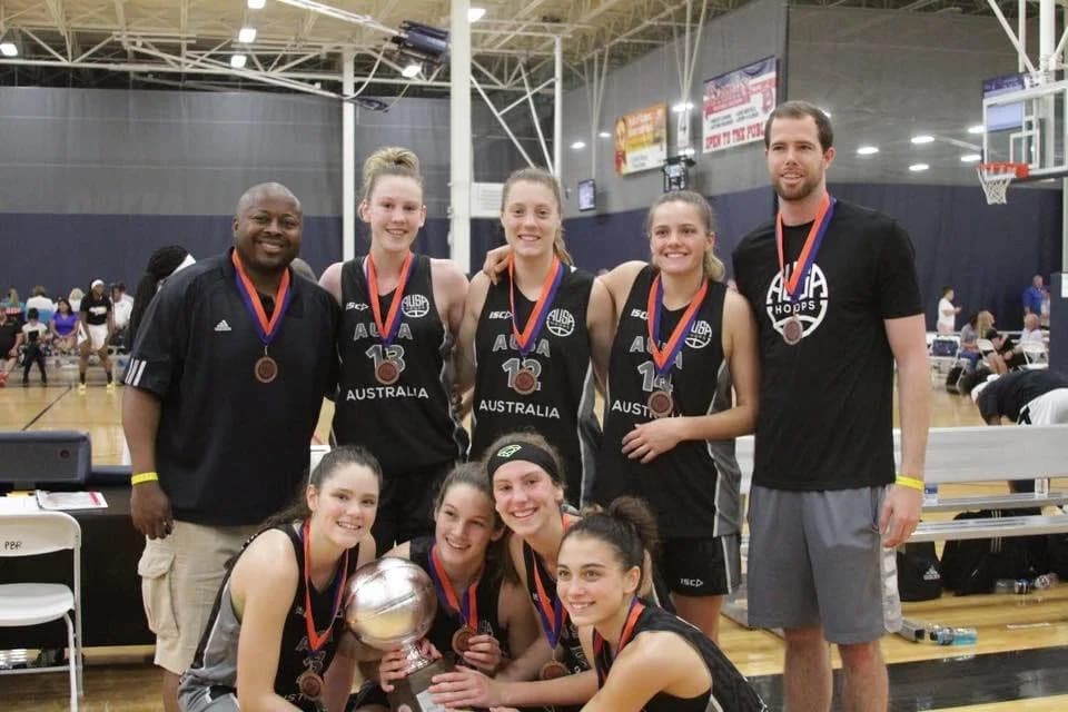 An AUSA Hoops girls tour squad with medals after a US AAU tournament