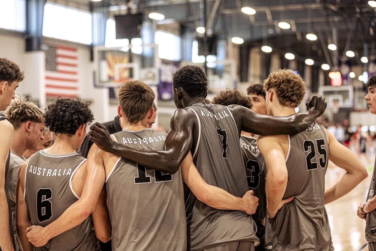 An AUSA Hoops squad huddled arm in arm in Australia jerseys after a game