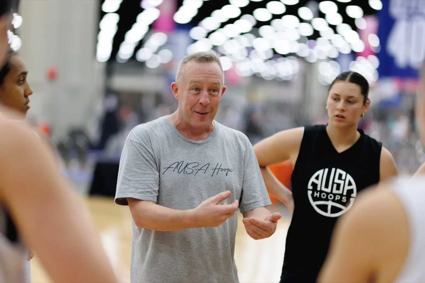 AUSA Hoops coach talking to players courtside during a game