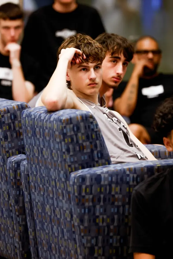 AUSA Hoops players listening during a team session on tour